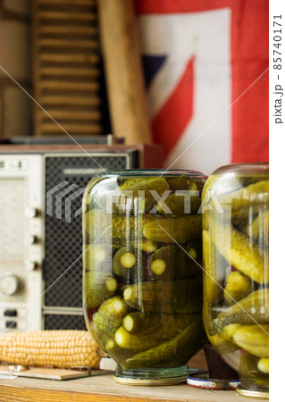 Pickles cucumbers in jars on rustic backgroud Pickles cucumbers in jars on rustic backgroud 85740171