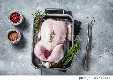 Whole raw Free range chicken in kitchen tray with herbs. Gray background. Top view 85741431