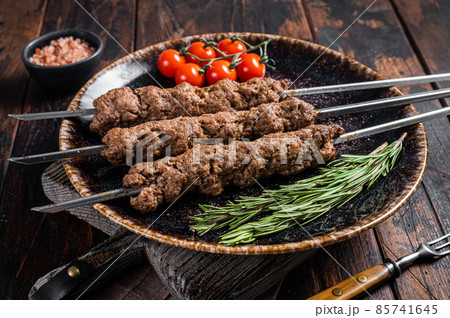 Grilled Shish kebab on skewers from minced lamb beef meat, Lula kebab. Wooden background. Top view 85741645