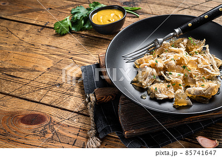 Chicken meat jelly in plate with mustard. Wooden background. Top view. Copy space 85741647