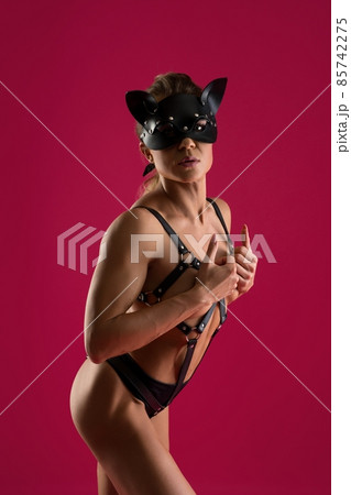 Alluring woman in BDSM mask and lingerie 85742275