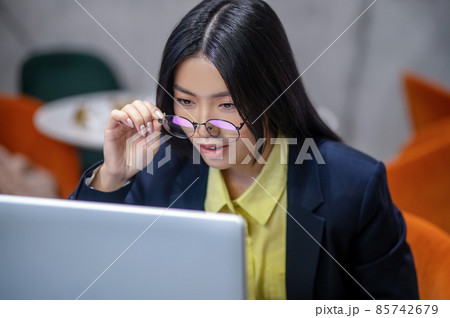 Asian business woman in the office working on a laptop Asian business woman in the office working on a laptop 85742679