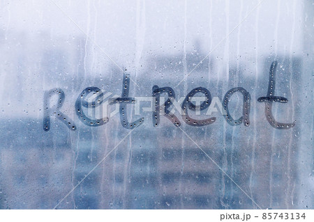 Lettering handwritten word Retreat on foggy blue window concept of reboot, goal setting, copy space 85743134