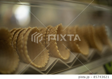 Waffle cones for ice cream. Sweets on the shop window. Waffle cones for ice cream. Sweets on the shop window. 85743621