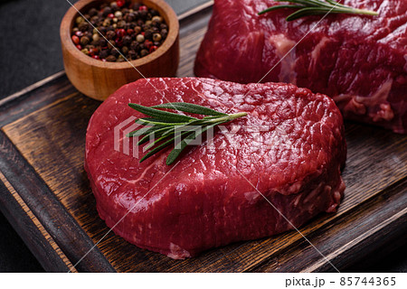 Raw fillet steak cooking on stone table. Raw meat 85744365