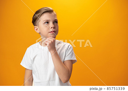 Teenager boy thinking looking away isolated on yellow background 85751339