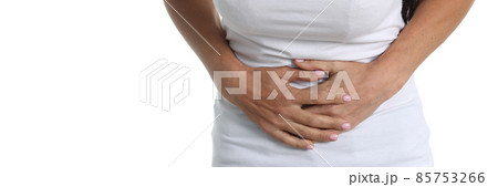 Woman with abdominal pain in white T-shirt and white background Woman with abdominal pain in white T-shirt and white background 85753266