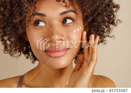 Cute lady using cosmetic product in studio 85755067