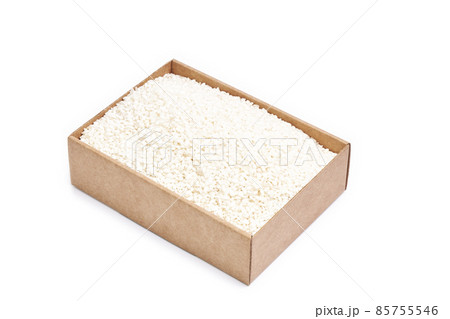 Cardboard box filled with white rice grains on a white background. Healthy food Cardboard box filled with white rice grains on a white background. Healthy food 85755546