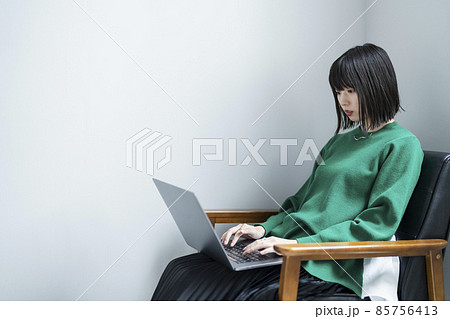 部屋でノートパソコンを使う女性 部屋でノートパソコンを使う女性 85756413