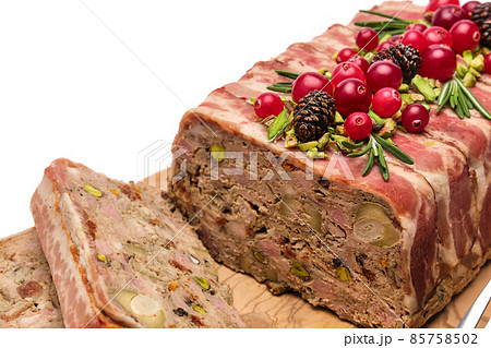 Traditional French terrine covered with bacon isolated on wooden cutting or serving board 85758502