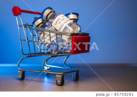 COVID-19 booster vaccine vials in shopping cart. Medicine and health care concept COVID-19 booster vaccine vials in shopping cart. Medicine and health care concept 85759291