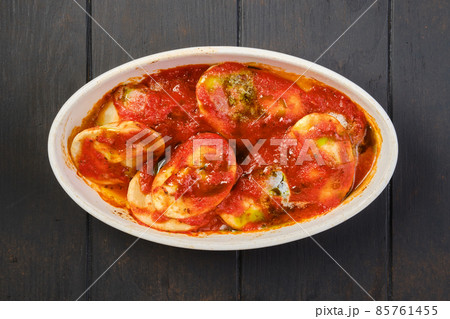 Overhead view of lamb dumplings with spicy tomato sauce baked in oven 85761455