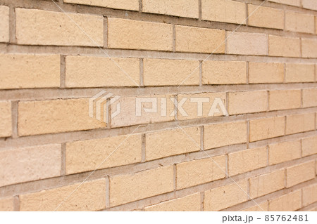 Beige brick outdoor wall of building background close-up. 85762481