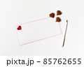 Romantic letter, white blank greeting card with a pen and heart-shaped chocolate candies on white 85762655