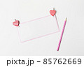Romantic letter, white blank greeting card with a pink pencil and heart-shaped decorations on white background 85762669