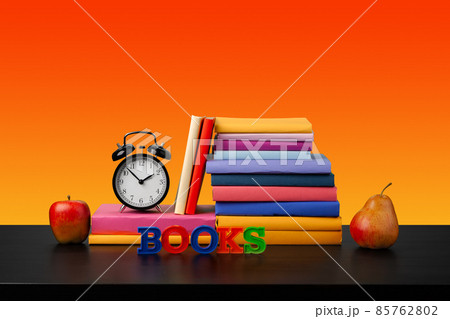 Stack of books on black wooden table 85762802