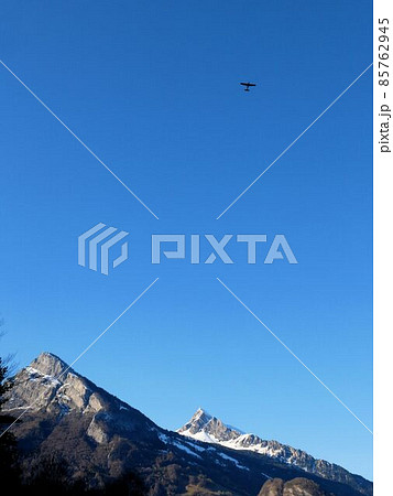 GonzenとAlvier山を背景に青空に上る飛行機　（スイス） 85762945