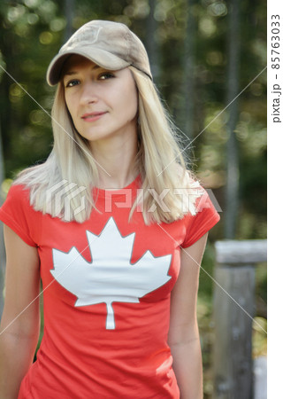 Girl in a T-shirt with a maple leaf symbol of Canada Girl in a T-shirt with a maple leaf symbol of Canada 85763033