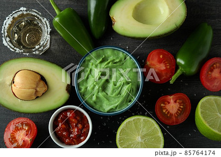 Party concept with tequila, guacamole and chips Party concept with tequila, guacamole and chips 85764174