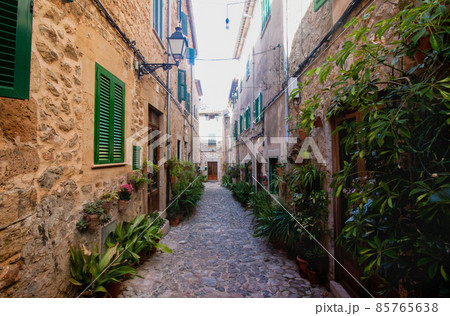 Beautiful street in Valldemossa, famous old mediterranean village of Majorca Spain. Beautiful street in Valldemossa, famous old mediterranean village of Majorca Spain. 85765638
