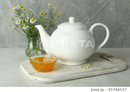 Concept of breakfast with chamomile tea on white textured table Concept of breakfast with chamomile tea on white textured table 85766537