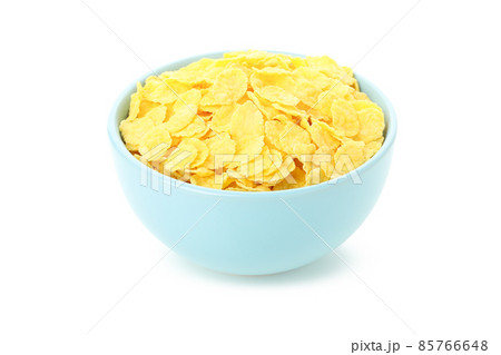 Plate of dry uncooked corn flakes isolated on white background 85766648