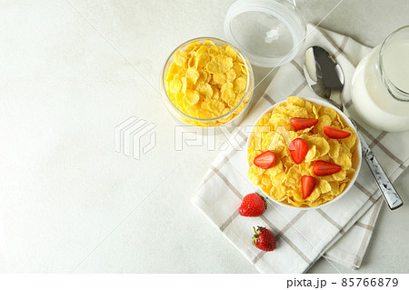 Concept of tasty breakfast with cornflakes on white textured table 85766879