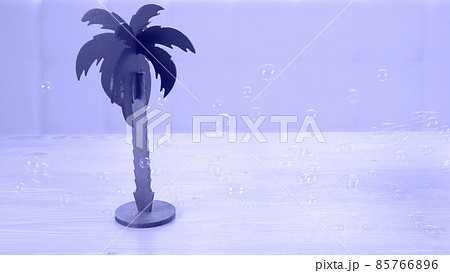 palm tree and rainbow soap bubbles on a white wooden table. Relaxation and imagination concept palm tree and rainbow soap bubbles on a white wooden table. Relaxation and imagination concept 85766896