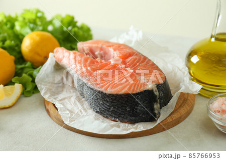Concept of cooking salmon on white textured background 85766953