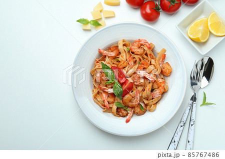 Plate of shrimp pasta and ingredients on white background Plate of shrimp pasta and ingredients on white background 85767486