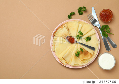 Concept of tasty food with crepes on beige background Concept of tasty food with crepes on beige background 85767566