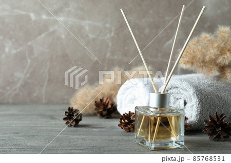 Diffuser and bath accessories on gray textured table Diffuser and bath accessories on gray textured table 85768531