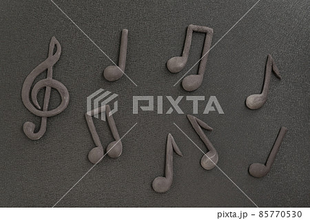 Treble clef and music notes on black background. Music symbol. Key of G. Violin key. Musical notation. Treble clef and music notes on black background. Music symbol. Key of G. Violin key. Musical notation. 85770530