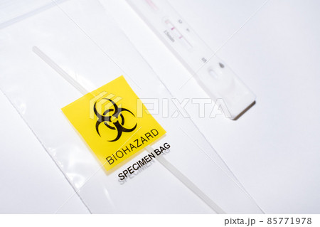 Positive covid self-test and swab in biohazard bag Positive covid self-test and swab in biohazard bag 85771978