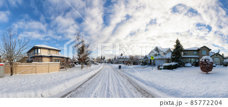 Residential Neighborhood in the Suburbs with White Snow covered road 85772204