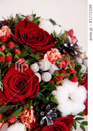Bouquet with red roses, cotton balls, cones, spruce and other flowers. Circle flowers bunch. Close up 85772399