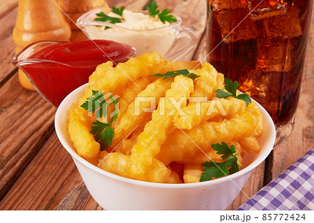 french fries on wooden table 85772424