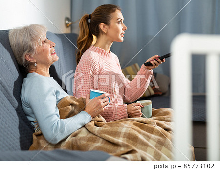 Grandmother and granddaughter watching TV 85773102