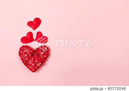 Red hearts on pink background. Minimalistic concept for valentine's day. Place for your text. Red hearts on pink background. Minimalistic concept for valentine's day. Place for your text. 85773246
