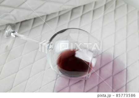 a spilled glass of wine on the tablecloth. Cleaning clothes and furniture from stains. a spilled glass of wine on the tablecloth. Cleaning clothes and furniture from stains. 85773586