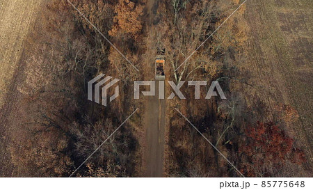 Aerial Drone View Flight Over Truck with an Empty Body Driving Along Dirt Road 85775648