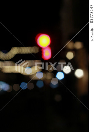 Out of focus defocused blurred bokeh of cars and traffic lights at night on city street. Out of focus defocused blurred bokeh of cars and traffic lights at night on city street. 85778247