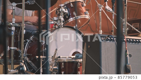 Concert, a man playing the drums. The concept of live, musical performance and virtuosity of playing percussion instruments 85779053