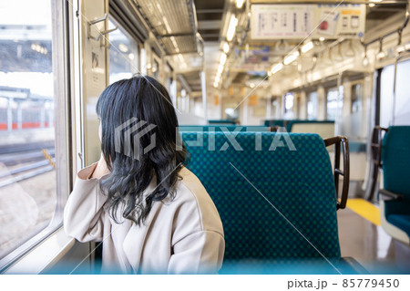 車窓から外を眺める女性　Cheek cane 85779450