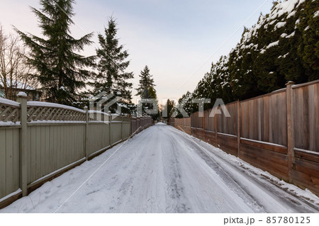 Alley with Snow in a residential neighborhood in the city suburbs 85780125