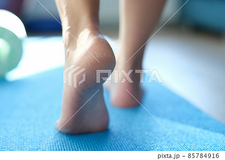 Barefoot dry feet make a step on a blue sports mat Barefoot dry feet make a step on a blue sports mat 85784916