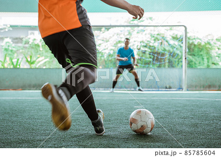 close up of futsal player's feet kicking the ball close up of futsal player's feet kicking the ball 85785604