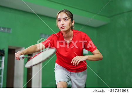 badminton player holding racket in ready position on court badminton player holding racket in ready position on court 85785668
