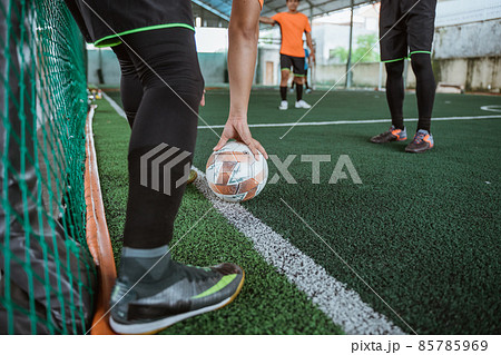the player's foot kicks the ball from the sideline the player's foot kicks the ball from the sideline 85785969